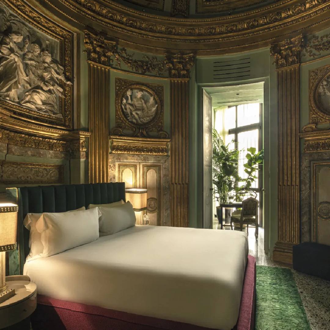 quarto de hotel decorado com obras de artes e afrescos antigos